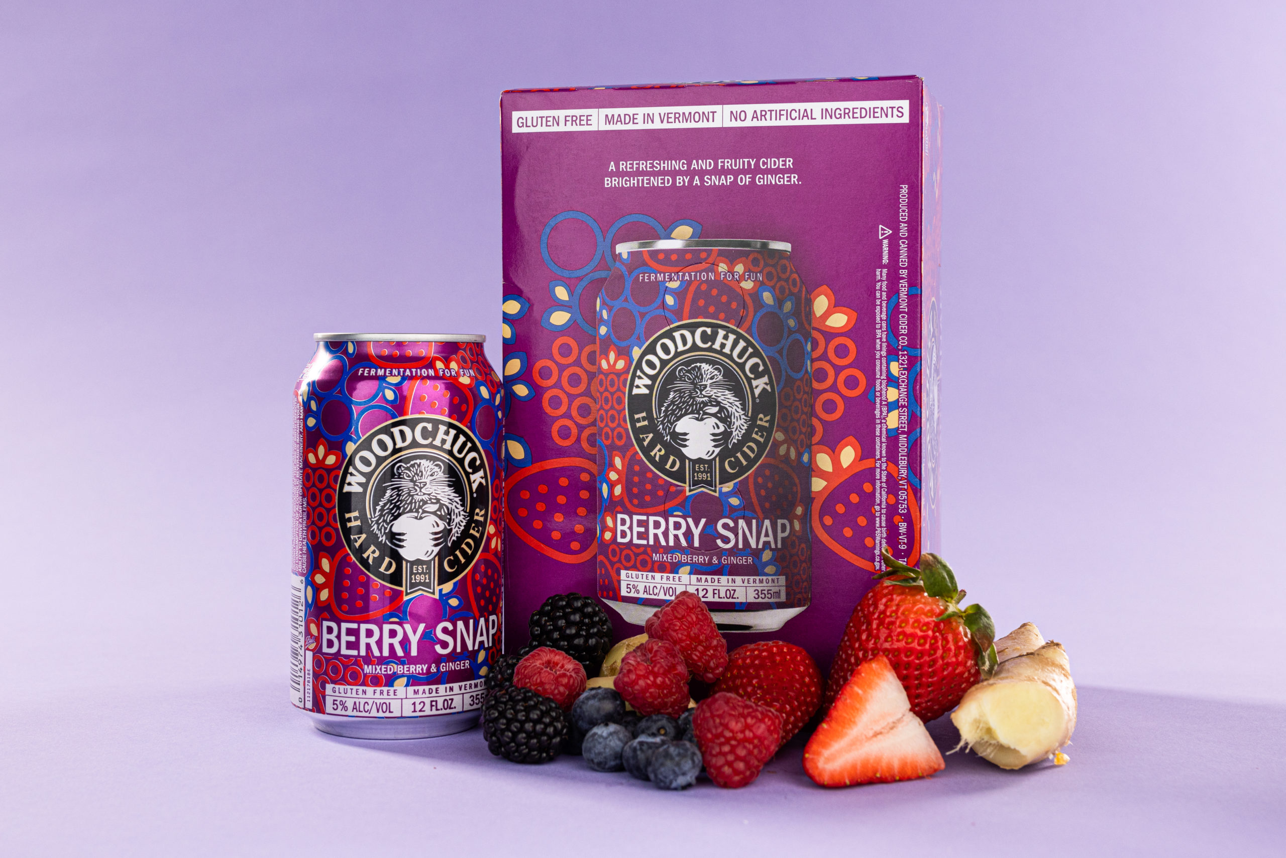 A 12 oz can and 6 pack of Woodchucks Berry Snap Hard Cider - Mixed Berry and Ginger- Surrounded by blackberries, raspberries, blueberries, strawberries, and ginger. The 6 pack reads " A refreshing and fruity cider brightened by a snap of ginger"